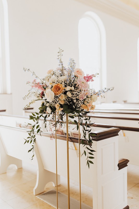 Kansas wedding florist spring pastel centerpiece on stand at church