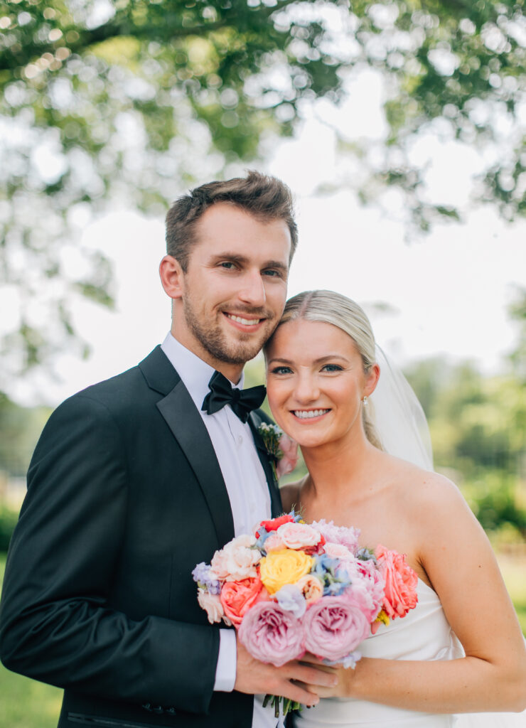 Missouri Wedding Florist summer wedding bride holding pink purple and yellow floral bridal bouquet